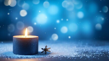 decoration with candle and snow on blue sparkling blurred background