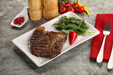 Grilled chuck roll steak with arugula