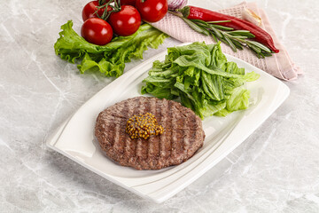 Frilled beef burger cutlet with iceberg