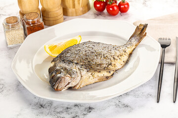 Baked Dorado fish served lemon