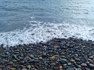 
Jeju Island beach with round basalt rocks.