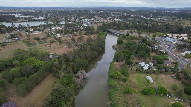 Larry Storey Bridge Spanning Logan River With View Of Tygum Lagoon And Park In Waterford, QLD, Australia. aerial sideways shot