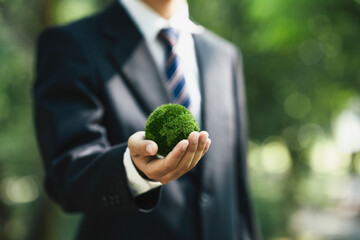 Sustainable Environment Business or Green Company concept. Business Hand Holding Green Globe to Organization Sustainable Development Environmental. Business Responsible for, Social, and Governance. 
