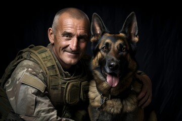 Soldier with his dog on a black background. Studio shot.