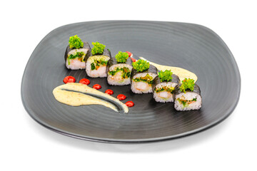 Sushi set of various products on a black stone plate