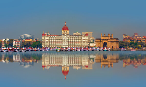 The Gateway of India and boats in the background Taj Mahal Hotel - Mumbai, India