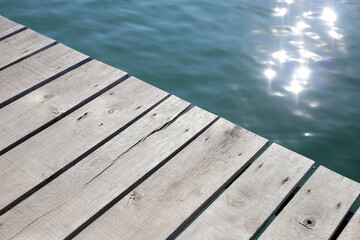 Fototapeta premium Wooden boardwalk with blue sea