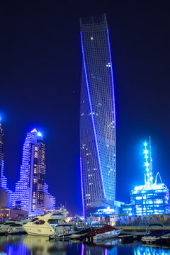 Dubai, UAE - March 31, 2014: Skyscrapers of Dubai Marina at night, UAE. Dubai Marina is a district in Dubai with artificial canal city who accommodates more than 120,000 people at Persian Gulf.