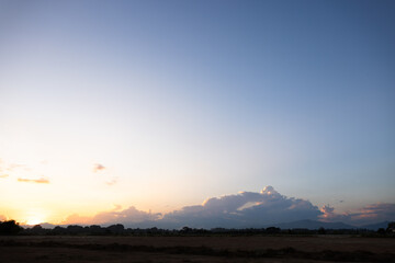 Beautiful sky and cloud at high. Landscape include space, light of nature, sunset, sunrise, horizon or skyline. Colorful with yellow, orange and blue at evening in autumn for background and wallpaper.
