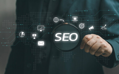 man holds a magnifying glass to search tools for SEO Marketing. SEO strategy that uses customizing...
