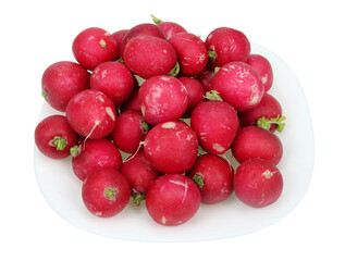A bunch of red fresh radishes on a plate isolated