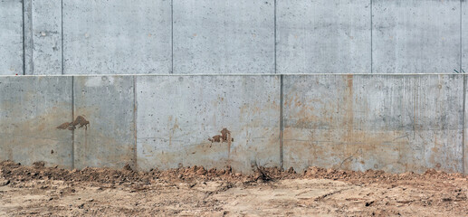 Concrete wall and sand in the construction of a new road