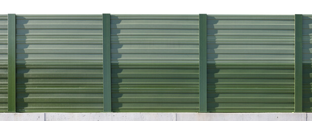 A long green fence made of steel sheets