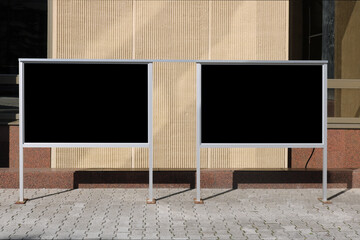 Advertising boards with black isolated surface near administrative building