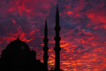 Islamic concept image. Silhouette of a mosque with dramatic clouds at sunset