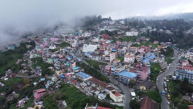 Scenic drone shot of Kodaikanal town under the cloudy sky, Dindigul, Tamil Nadu, India