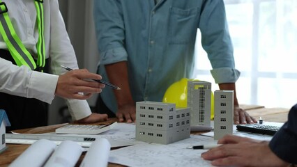 Projects work with partners and engineering tools to model and validate construction projects and work with on-site blueprints. Construction and structural concepts of engineer or architect meeting.