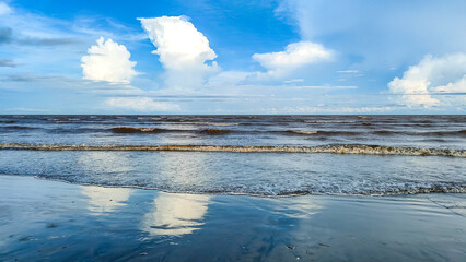 waves on the sea landscape on a background of blue sky with clouds at Pantai Anak Air, Kuantan Pahang, Malaysia.

