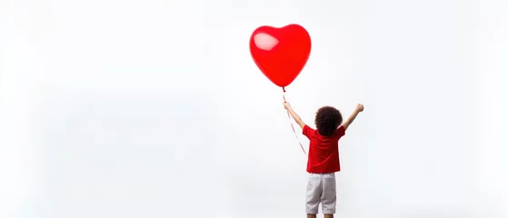 Tuinposter Back view of a kid raising arms with red love valentine heart shaped balloon isolated on white background © LightoLife
