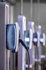 EV charging and electric car, Electric car charging station for charge EV battery, Plug for vehicle with electric engine, EV charger clean energy, Charging point at car parking lot.