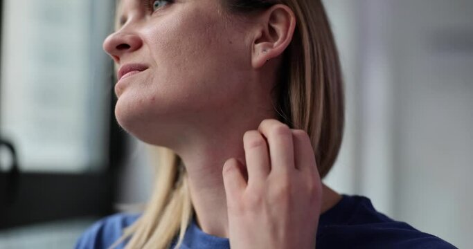Woman with neurosis scratching her neck with hand closeup 4k movie slow motion