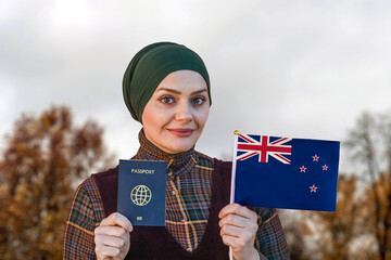 Muslim Woman Holding Passport and Flag of New Zealand
