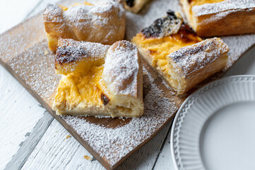 Puff pastry cake with delicious sour cream lemon filling on light background