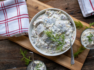 Traditional german herring salad mit apples, pickles and onions