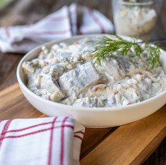 Traditional german herring salad mit apples, pickles and onions