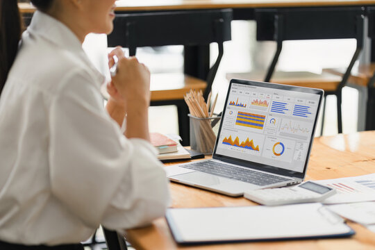 Analyst woman working with information database to analyze marketing and sales data. Business analytics dashboard with charts, metrics, and KPIs concept.