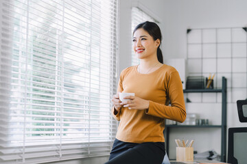 Contemplative businesswoman professional on a coffee break during remote working at home office.
