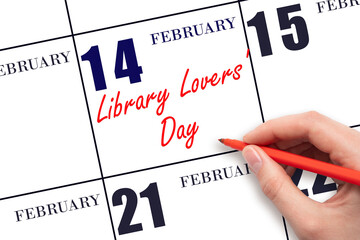 February 14. Hand writing text Library Lovers' Day on calendar date. Save the date.