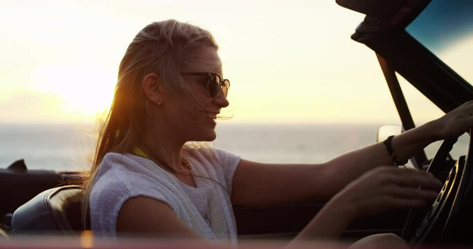 Woman, road trip and freedom at sunset at the sea in a car with drive for holiday, adventure and travel outdoor. Transport, wind and ocean with vacation and nature with a female driver in a vehicle