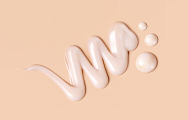 cosmetic smear of creamy texture on a beige background