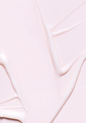 cosmetic smear cream texture on pastel pink background