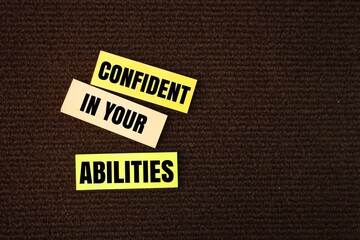 colored paper with the words confident in your abilities. the concept of self-confidence