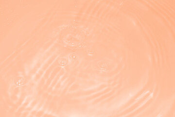 The surface of the water dripped and rippled in the basin. The transparent orange water surface is...
