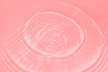 The surface of the water dripped and rippled in the basin. The transparent red water surface is slightly shaded with unclear details