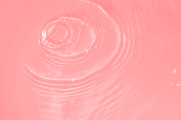 The surface of the water dripped and rippled in the basin. The transparent pink water surface is...