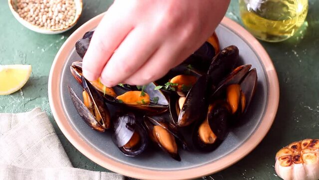 Cooked mussels with oil and parsley. Sea food. Healthy eating. Diet.