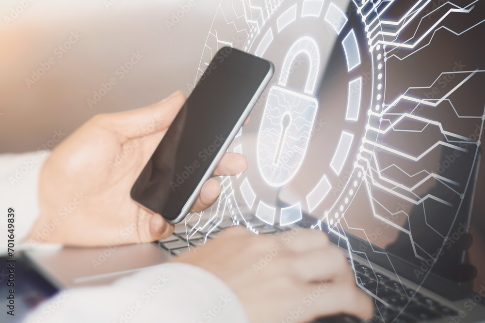 Poster close up of male hands using laptop and mobile phone with creative glowing round padlock hologram wi