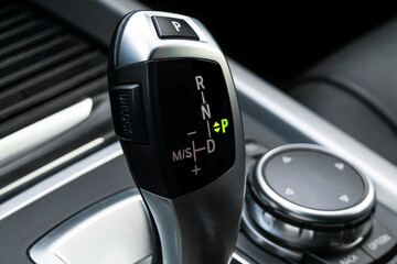 Automatic gear stick of a modern car. Car interior details. Transmission shift.