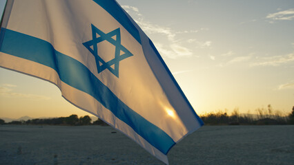 Israel national flag waving on sky background 