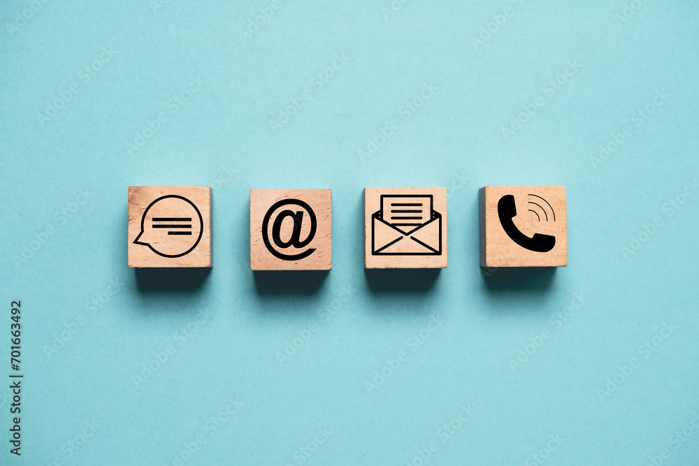 Poster contact icons include message address e-mail and telephone on wooden block cube and blue background 