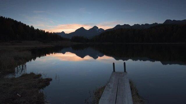 Sunrise at Lej da Staz (Stazersee) with jetty in Engadin, Switzerland