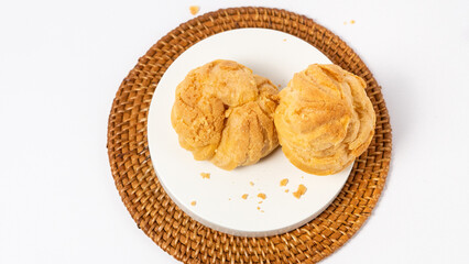 Freshly baked cream puffs or Vanilla eclairs isolated on white background