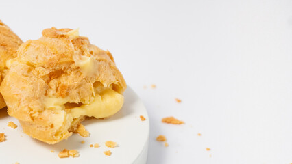 Freshly baked cream puffs or Vanilla eclairs isolated on white background