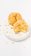 Freshly baked cream puffs or Vanilla eclairs isolated on white background