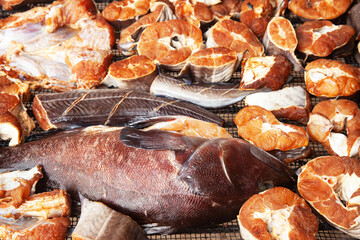 Pieces of fresh fish are dried on a steel mesh.