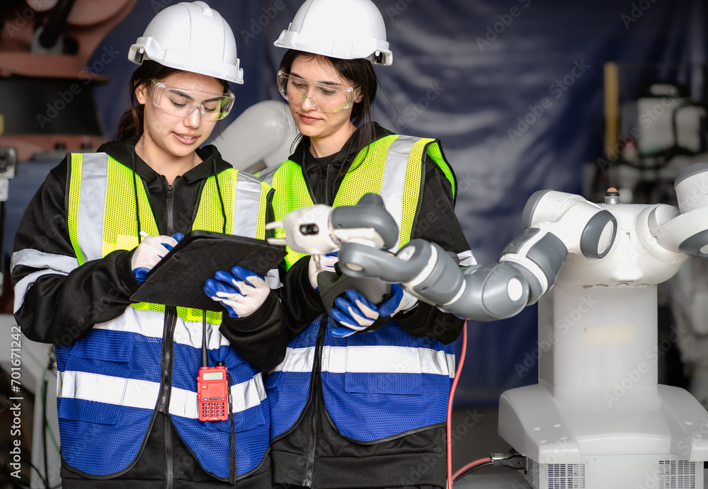 Wall mural mechanical engineering people training, programming automated ai robot arms connection at production